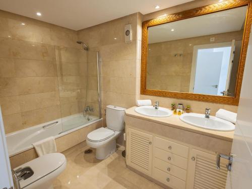 a bathroom with a toilet and a sink and a mirror at VACATION MARBELLA I Puerto Banus Sea Front, Terrace, Puerto Banus Marina, Pool in Marbella
