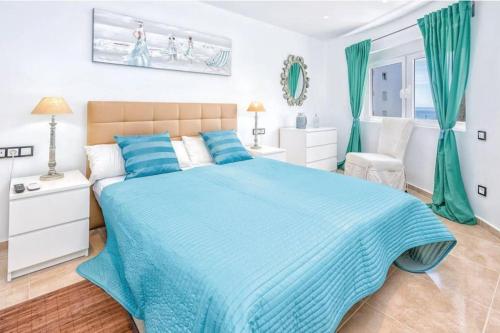 1 dormitorio con 1 cama grande con sábanas azules en CT 191 - Perla de Algaida II en Sitio de Calahonda