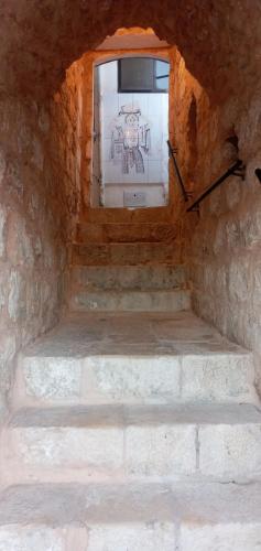 a window in a stone room with stairs in front at Jaffa Gate Hostel in Jerusalem