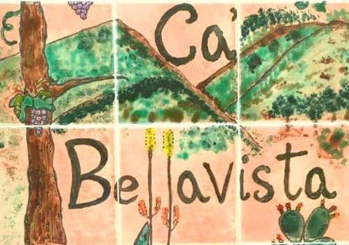 a tile wall with a tree and the words bella brazil at Ca Bellavista in Vega de San Mateo