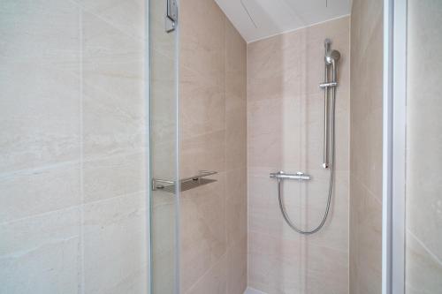 a shower with a glass door in a bathroom at Vienna Residence, Marina Tower - Danube in Vienna