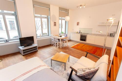 a living room with a couch and a tv at FullHouse - Leipzig - M14 Apartments - Balcony - SmartTV in Leipzig