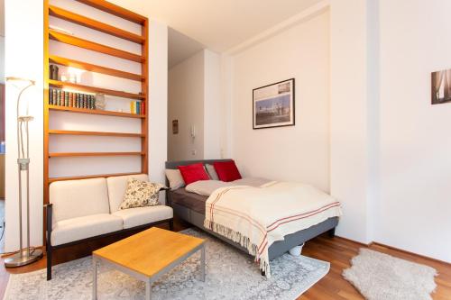 a small bedroom with a bed and a couch at FULL HOUSE Premium Apartments Leipzig M14 in Leipzig