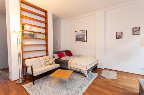 a living room with a couch and a table at FullHouse - Leipzig - M14 Apartments - Balcony - SmartTV in Leipzig