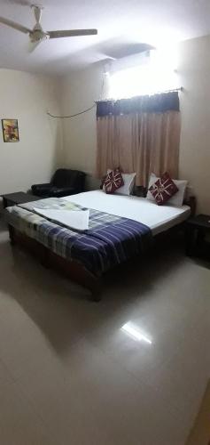 a bedroom with a large bed with a blue blanket at Brookefield Service Apartment in Bangalore