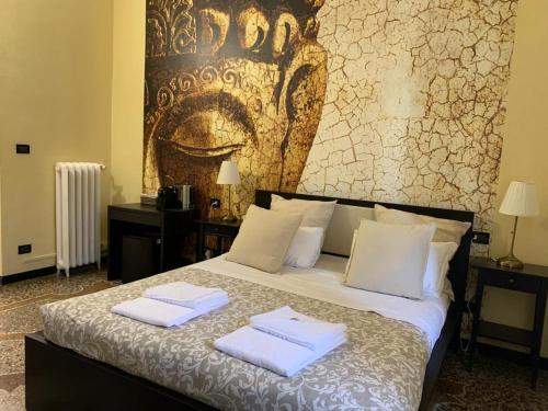a bedroom with a bed with two towels on it at Domus La Foce Hotel self check in in Genova