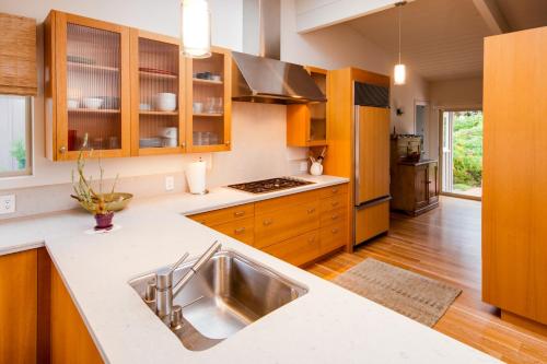 a kitchen with wooden cabinets and a stainless steel sink at Dream Scape in Fort Bragg