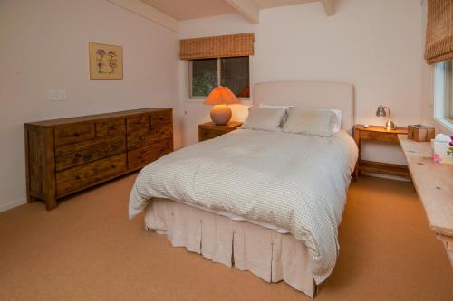 a bedroom with a bed and a dresser and a window at Dream Scape in Fort Bragg