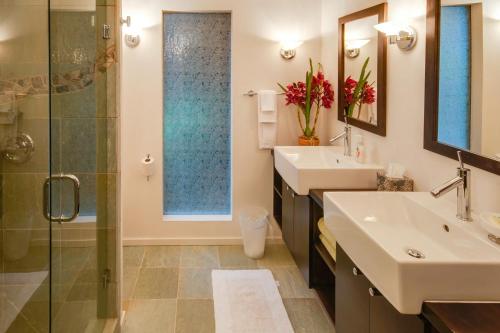 a bathroom with two sinks and a glass shower at Dream Scape in Fort Bragg