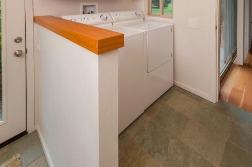 a kitchen with a white washer and dryer at Dream Scape in Fort Bragg