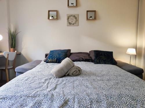 a white bed with towels on top of it at Studio Harmony - Zen et Confort - Hypercentre in Troyes