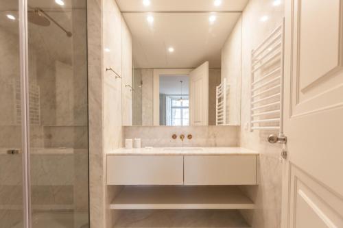 a bathroom with a sink and a shower at FLH Praça Rossio Contemporary Flat in Lisbon