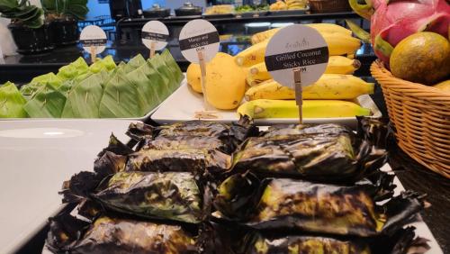 a display of bananas and other fruits and vegetables at DUM Hotel - Si Phum in Chiang Mai