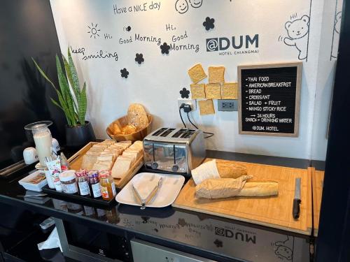 a counter with some bread and a toaster on it at DUM Hotel - Si Phum in Chiang Mai