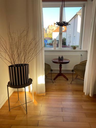 a dining room with a table and a chair and a window at Ferienwohnung Bett & Burg in Wertheim