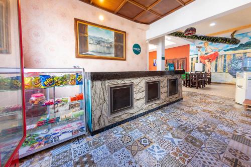 a fireplace in a room with a tile floor at Hotel Ayenda Macondo in Manizales