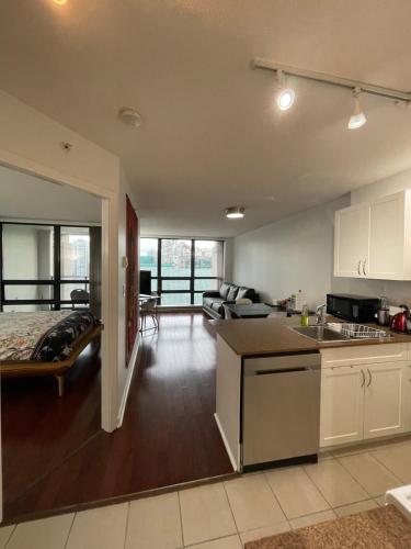 an open kitchen and living room in a house at Vancouver Downtown Central 1 bedroom Condo in Vancouver