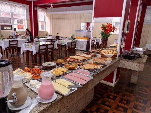a buffet of food on a table in a restaurant at Grande Hotel Torres in Torres