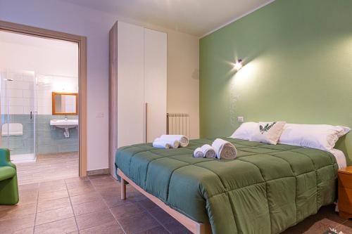 a bedroom with a bed with two towels on it at Locanda Sighimi in Lanusei