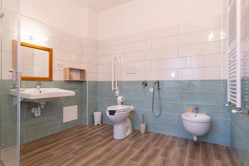 a bathroom with a toilet and a sink and a shower at Locanda Sighimi in Lanusei