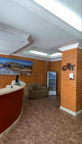 a lobby with a couch and a drink machine at Grande Hotel Torres in Torres