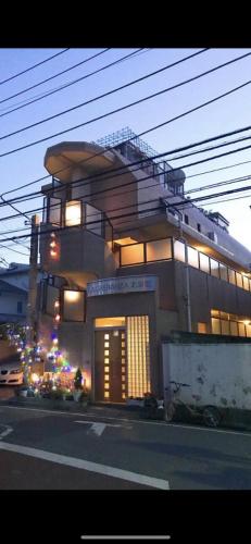 a large building with a staircase on top of it at 桜の宿28 square meter king size bed with sofa bed, garden room102 in Tokyo