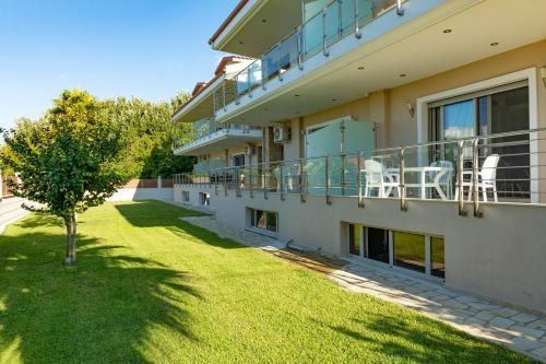 a balcony of a house with a grass yard at Toroni Luxury Villas in Toroni