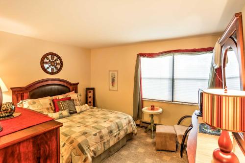 a bedroom with a bed and a window at Waterfront Port Clinton Condo with Pool Access! in Port Clinton