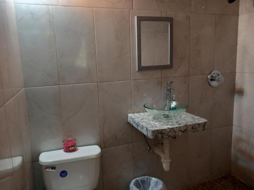 a bathroom with a sink and a toilet at Habitat Apartments in Gros Islet