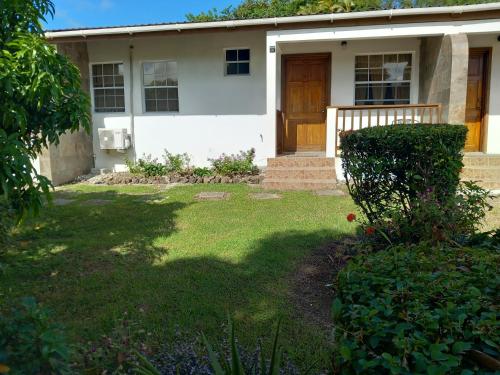 a house with a grass yard in front of it at Habitat Apartments in Gros Islet