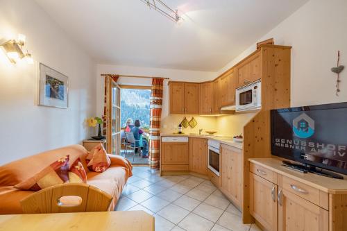 a kitchen and living room with a couch and a tv at Genusshof Mesner Aktiv in Liesing