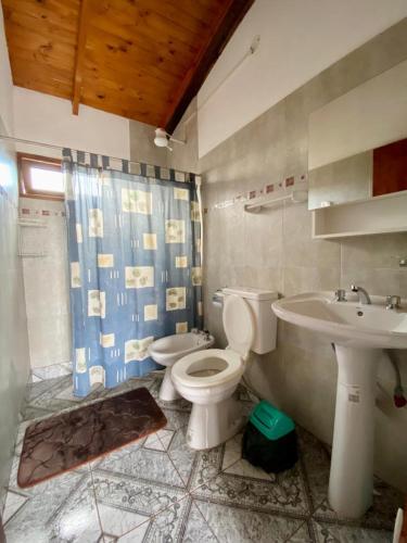 a bathroom with a toilet and a sink at Cabañas Aranderay in Puerto Esperanza