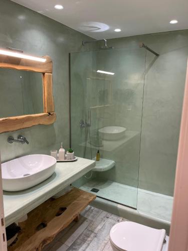 a bathroom with a sink and a glass shower at Luxurious Villa in Mykonos with Pool in Agios Ioannis Mykonos