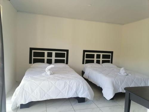 Uma cama ou camas num quarto em Casa Chika Playa Grande