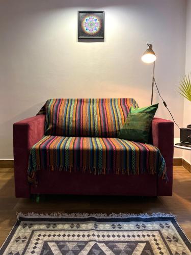 a red couch sitting in a living room at HealthyStudio512 Apartments in Kotor