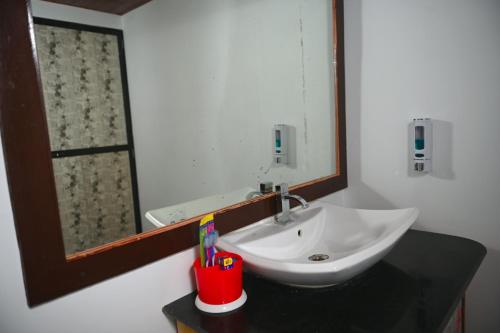 a bathroom with a sink and a mirror at Madhu Huts Agonda in Agonda