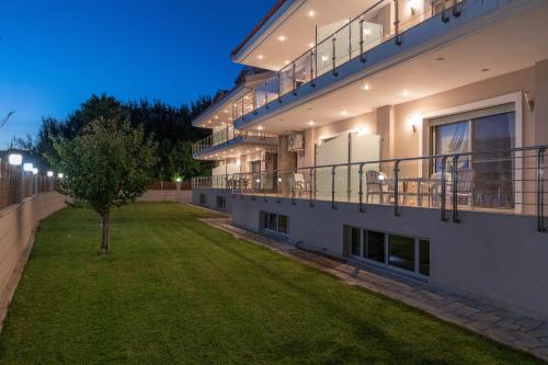 a large apartment building with a yard at night at Oniro Luxury Villas in Toroni