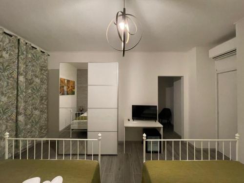 a bedroom with a bed and a desk with a laptop at Foresteria Opera B&b in Rovato