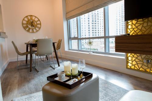 a living room with a table and a large window at Boutique Living - Park Island in Dubai