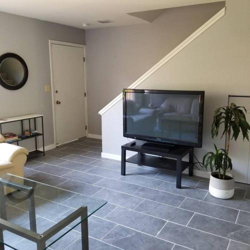 a living room with a flat screen tv on a table at Entire 2 level townhouse in Old Town Scottsdale! in Scottsdale