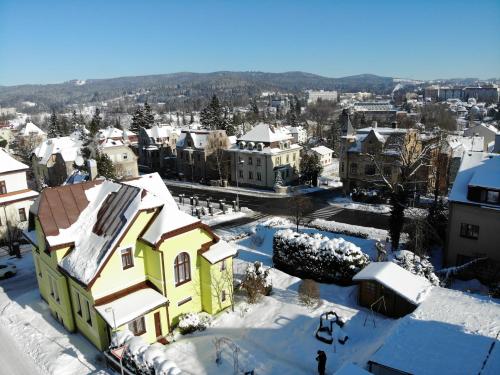a city with snow covered roofs and buildings at Penzion Pokorny in Jablonec nad Nisou