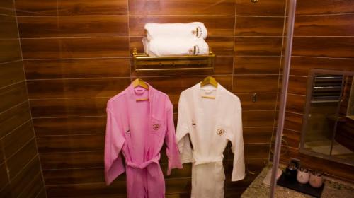 two shirts and coats hanging on a wall at TN MAX LUXURY HOME in Enugu