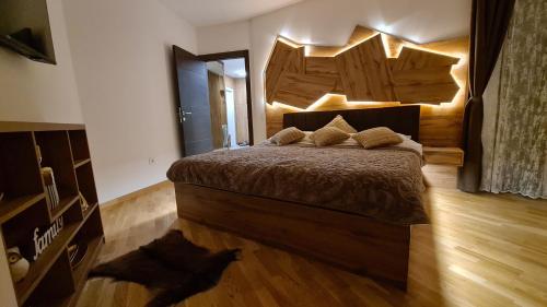 a bedroom with a bed and a cat laying on the floor at Palace 15 in Zlatibor