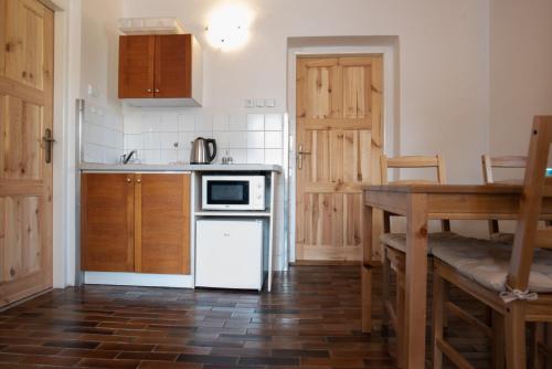 a kitchen with a sink and a stove top oven at Pension Styl in Bedřichov