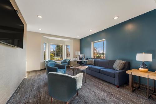 a living room with a couch and chairs at SureStay Plus Hotel by Best Western Highland Poughkeepsie in Highland