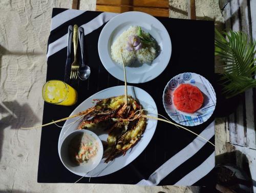 a table with three plates of food on a table at Rashuthere Maldives in Rasdu