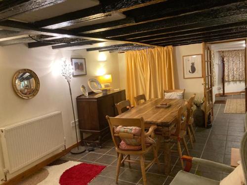 a dining room with a wooden table and chairs at Bodwyn house in Dolgellau