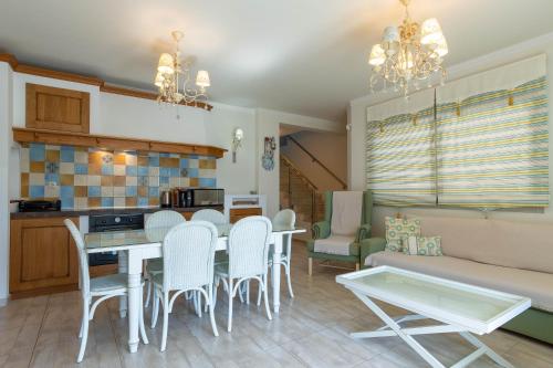 a kitchen and living room with a table and chairs at Oniro Luxury Villas in Toroni