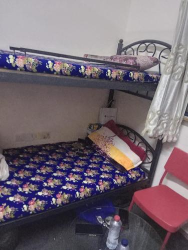 a bedroom with a bunk bed with a flower pattern at dormitory bed space for male and female in Sharjah