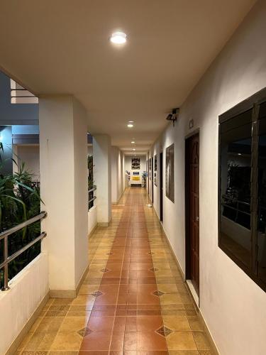 a hallway of a building with a tile floor at JJ Palace เจเจ พาเลซ in Ban Si Than